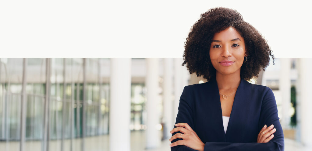 Professional individual in an office setting, illustrating confidence and clarity during a midyear employee benefits strategy review.